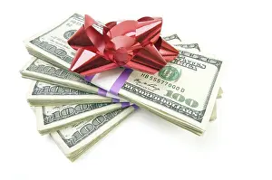 Plain Colored Background Stock Photo Drucke: Stack of money with bow isolated on a white background