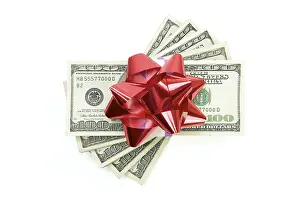 White Background Finance Drucke: Stack of money with bow isolated on a white background