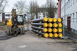 District Heating Pipes Drucke: A stack of new district heating pipes on a construction site in Dusseldorf