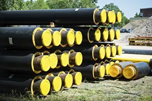 Alternative Energy Technology Drucke: A stack of new pipes for district heating at a construction site in Dusseldorf