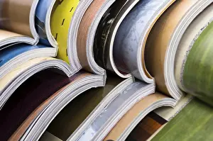 Environmental Conservation Through Reuse Drucke: Stack of open magazines