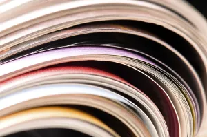 Environmental Conservation Through Reuse Drucke: Stack of open magazines