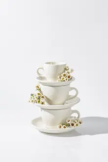 Spring Flowers Arrangement Drucke: Stack of white ceramic cups with small spring flowers adorning each
