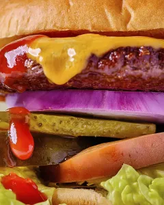 High Calorie Food Photography Drucke: A stacked cheeseburger featuring a beef patty