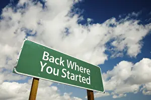 Cloudy Sky Image Drucke: Back where you started road sign with dramatic clouds and sky