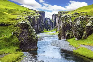 Northern Europe Tourism Drucke: Steep vertical cliffs surround the stream of very cold water