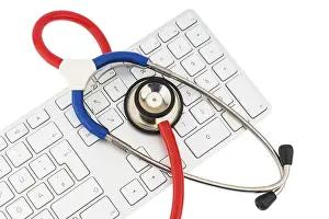 Healthcare System Concept Image Drucke: Stethoscope and keyboard of a computer