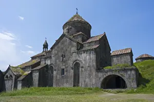 UNESCO World Heritage Site Armenia Drucke: Stone monastery with several structures and domes in front of a wide meadow