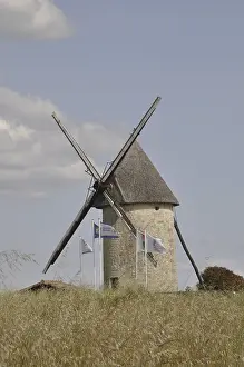 Cloudy Blue Sky Photo Drucke: A stone windmill under a blue sky with clouds