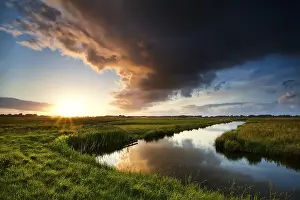Dutch Countryside Drucke: Storm cloud at dramatic sunset in summertime