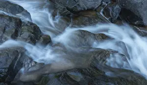 Nature Photography Europe Drucke: A stream that flows over rocks and creates a soft