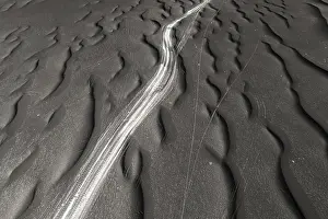 Black And White Coastal Photography Drucke: A striking image capturing the unique textures of black sand