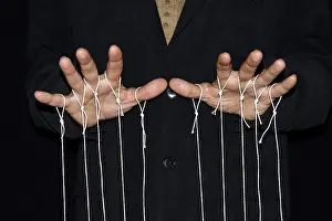 Studio Photography Black Background Drucke: String-pulling puppeteer, studio photography with black background