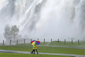Ireland Waterfalls Drucke: Strollers with colourful umbrella in front of waterfall