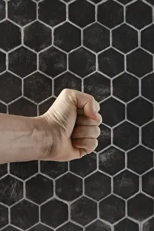 Artistic Expression Drucke: A strong fist is positioned in front of a textured hexagonal pattern
