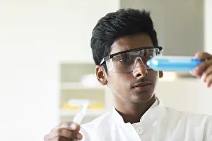 European Education System Drucke: Student in an internship at the university with sample and lab coat