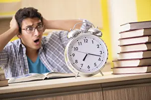 Student Studying At Home Drucke: Student preparing for exam sitting at the kitchen