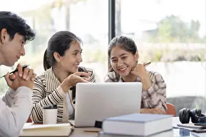 Indoor Educational Space Drucke: Three students working together on a laptop
