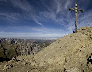 European Mountainous Landscape Drucke: Summit cross at the peak of Mt