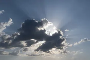 Desolate Landscape Drucke: Sun behind a cloud with rays of light
