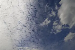 Outdoor Photography Drucke: Sun hidden by large fleecy clouds (Altocumulus)
