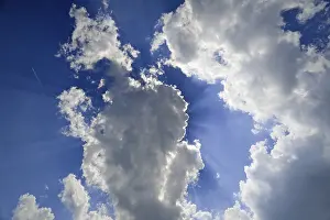Cloud Formation Photography Drucke: Sun hiding behind clouds in the sky