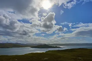 British Countryside Landscape Drucke: Sun rays break through the clouds over a calm lake