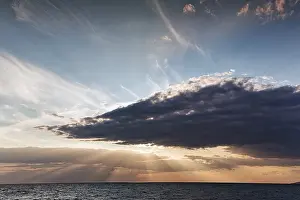 Northern Europe Sunset Photography Drucke: Sunbeams behind clouds, dramatic evening sky