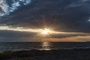 Northern Europe Sunset Scene Drucke: Sunbeams through gap in clouds