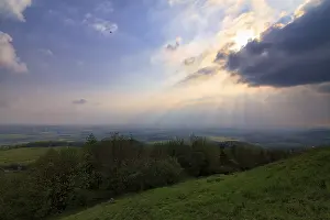 Thunderstorm In Europe Drucke: Sunbeams behind thunderclouds, mountain top