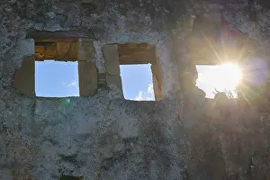 Deserted Greek Village Drucke: Sunlight falls through window openings of an old