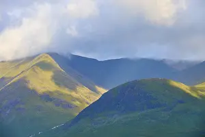 Mountain Chain Europe Drucke: Sunlight illuminates mountainous landscape surrounded by clouds