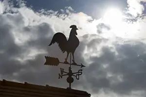 Dramatic Cloud Formations Europe Drucke: Sunlit weather vane in front of dramatic cloud formations