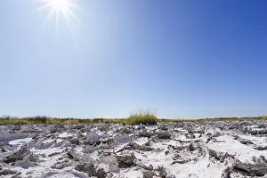 Namibia Desert Landscape Photography Drucke: Sunrays shine on drought mud patterns