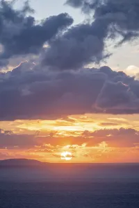 Cloudy Sky Greece Drucke: Sunrise behind the clouds, atmospheric dramatic cloudy sky