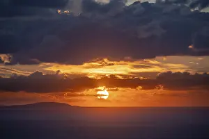 Deserted Greek Island Drucke: Sunrise behind the clouds, atmospheric dramatic cloudy sky