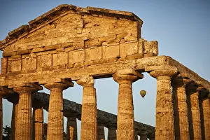Evening Light In Europe Drucke: Sunset behind ancient columns of a temple with a clear sky