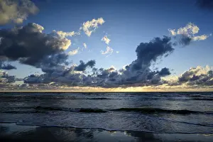 Deserted Dutch Coastline Drucke: Sunset on the beach, with cloudy sky and surf