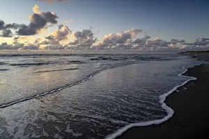 Deserted Dutch Coastline Drucke: Sunset on the beach, with cloudy sky and surf