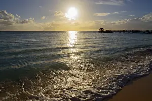 Deserted Beach Evening Drucke: Sunset on the beach with a view of a jetty