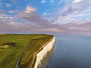 Evening Light On Rocky Cliffs Drucke: Sunset over Beachy Head Lighthouse from a drone
