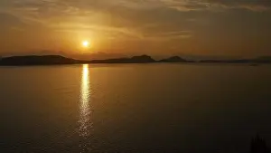 Southeast Europe Nature Scenes Drucke: The sunset casts warm light over the still water