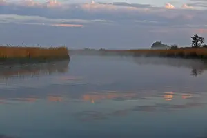 Cloud Formation Germany Drucke: Sunset with cloud formation and reflection in the water on the river Trebel