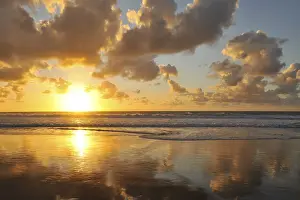 Backlit Cloud Formation Drucke: Sunset and clouded sky reflected in the Atlantic Ocean