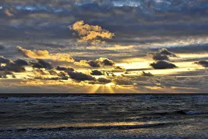 Evening Light In The Netherlands Drucke: Sunset with clouds on the beach