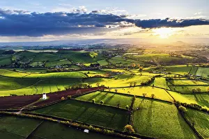 Sunset In Northern Europe Drucke: Sunset of Devon Windmill over Fields and Farms from a drone