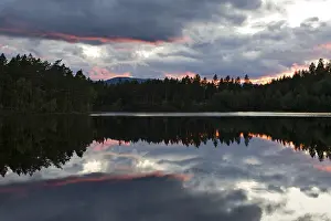 Cloudy Sky Reflections Drucke: Sunset over a lake near Ormemyr