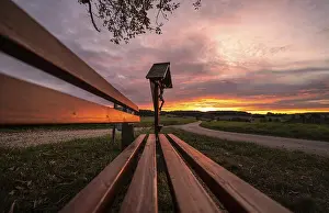 Central Europe Evening Sky Drucke: Sunset at a memorial and a bench in front of it