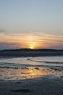 German Beach Scene Drucke: Sunset on a quiet beach with soft light on the waves