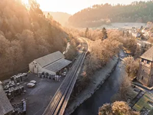 Black Forest Evening Scene Drucke: Sunset over a railway line and river